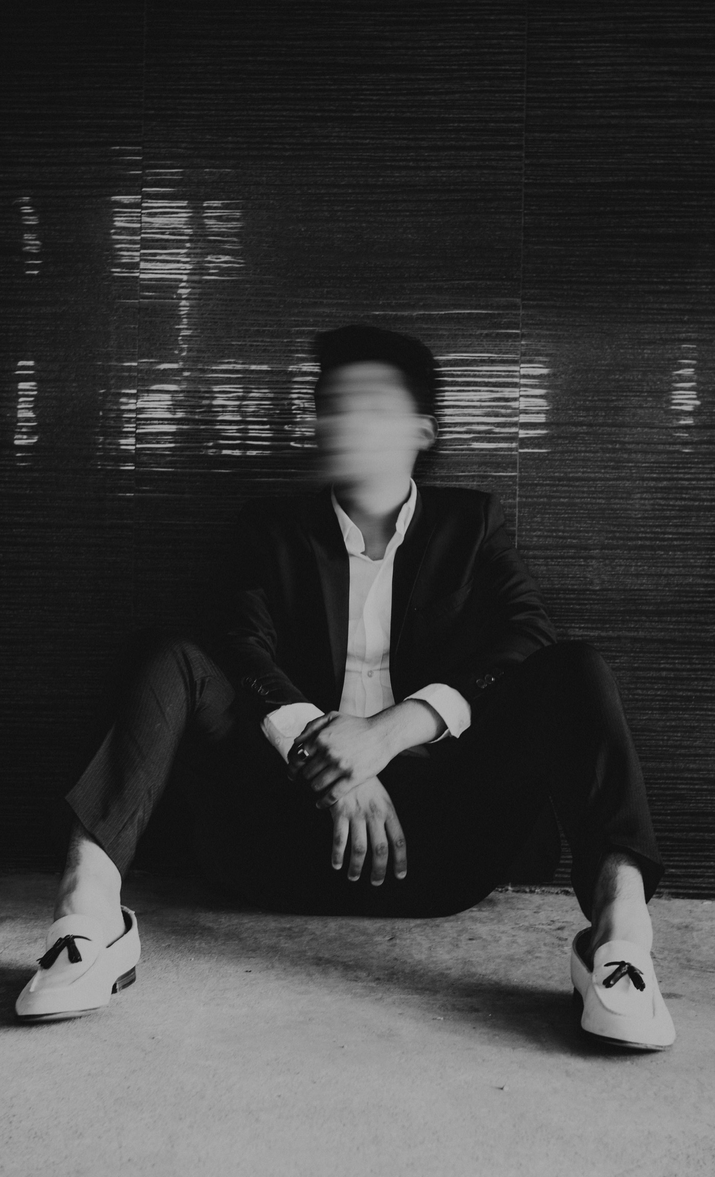 A blurred figure in a suit, the overwhelm of always-on communication