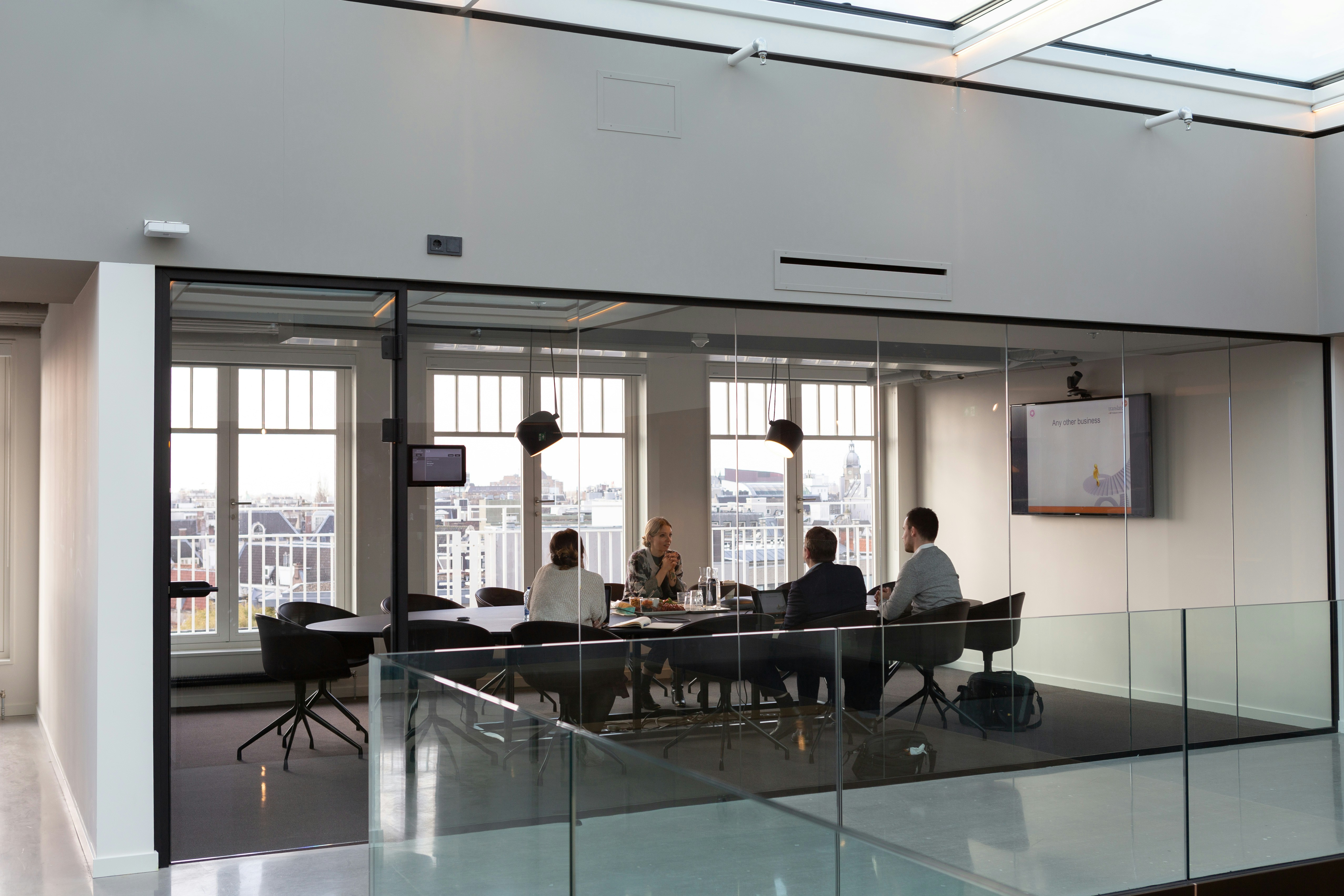 A team meeting in a calm, glass-walled office